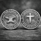 Two metallic coins with symbols and text on a dark background